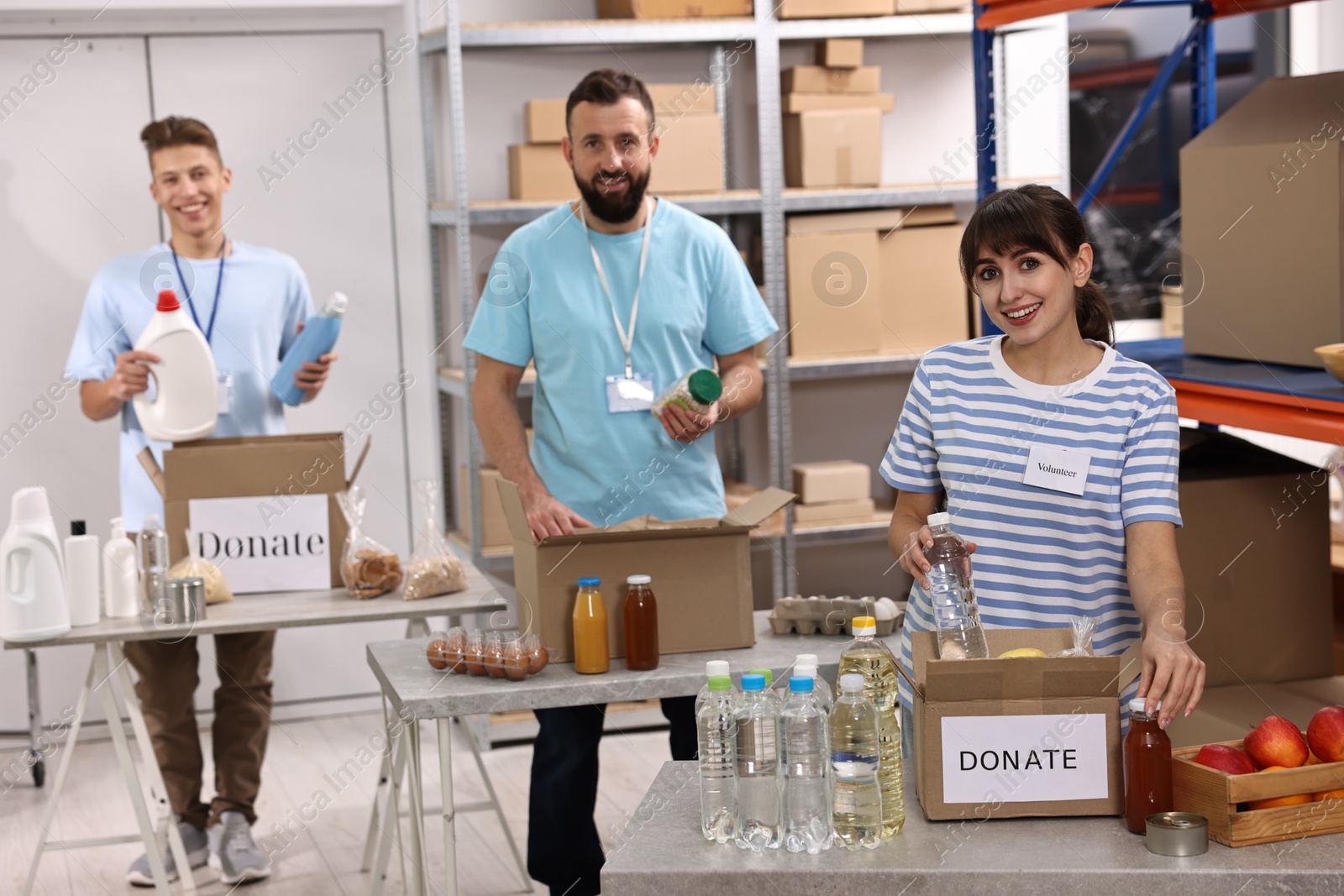 Photo of Volunteers packing donation goods at tables indoors