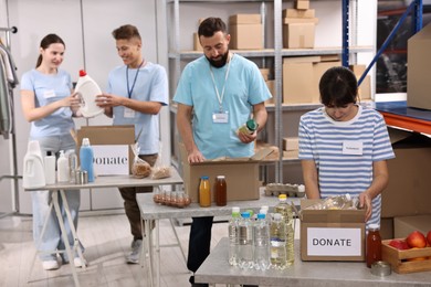 Photo of Volunteers packing donation goods at tables indoors