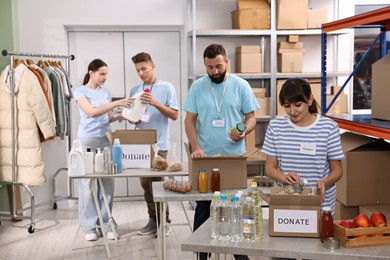 Photo of Volunteers packing donation goods at tables indoors