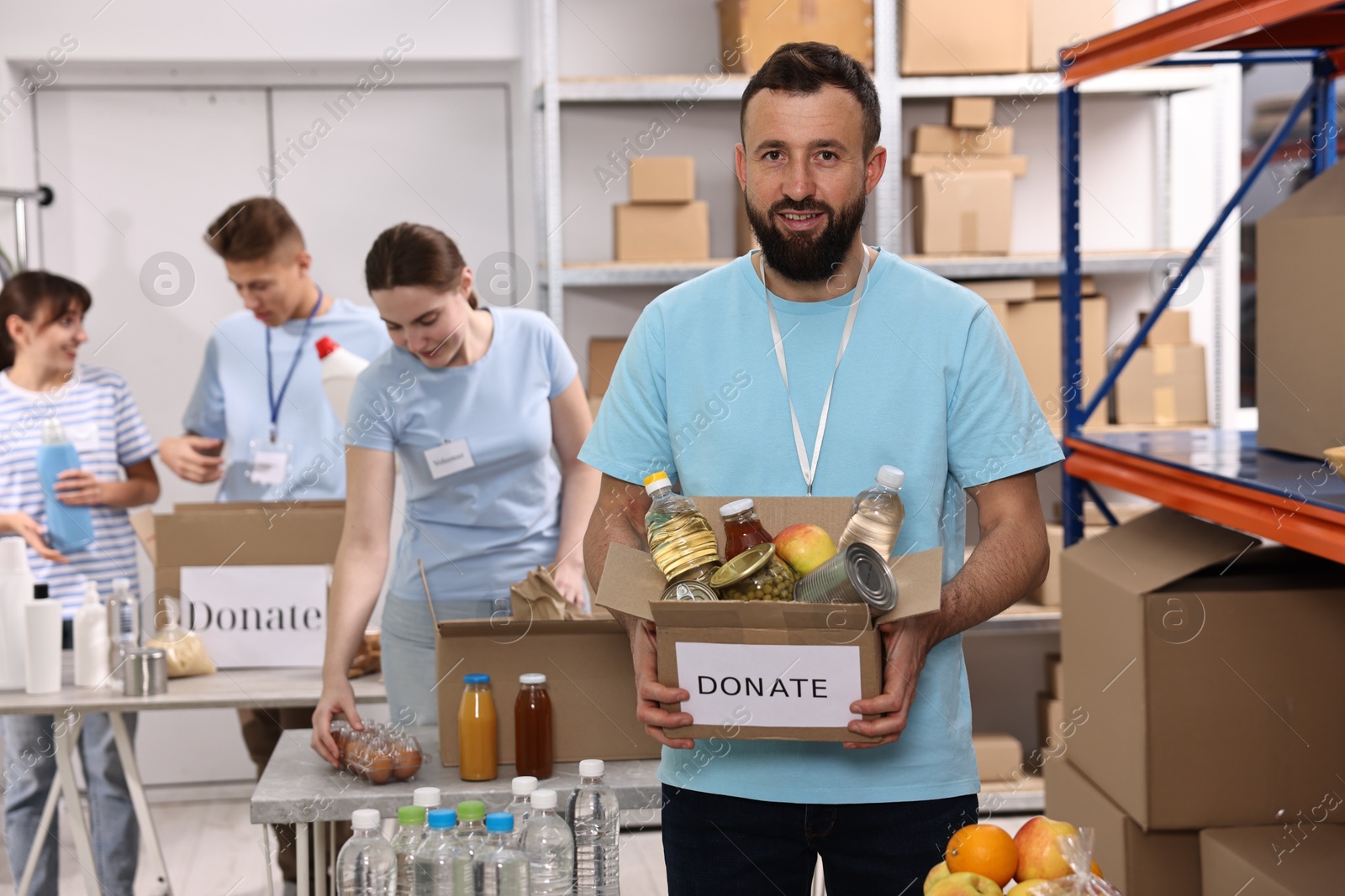 Photo of Group of volunteers packing donation goods indoors