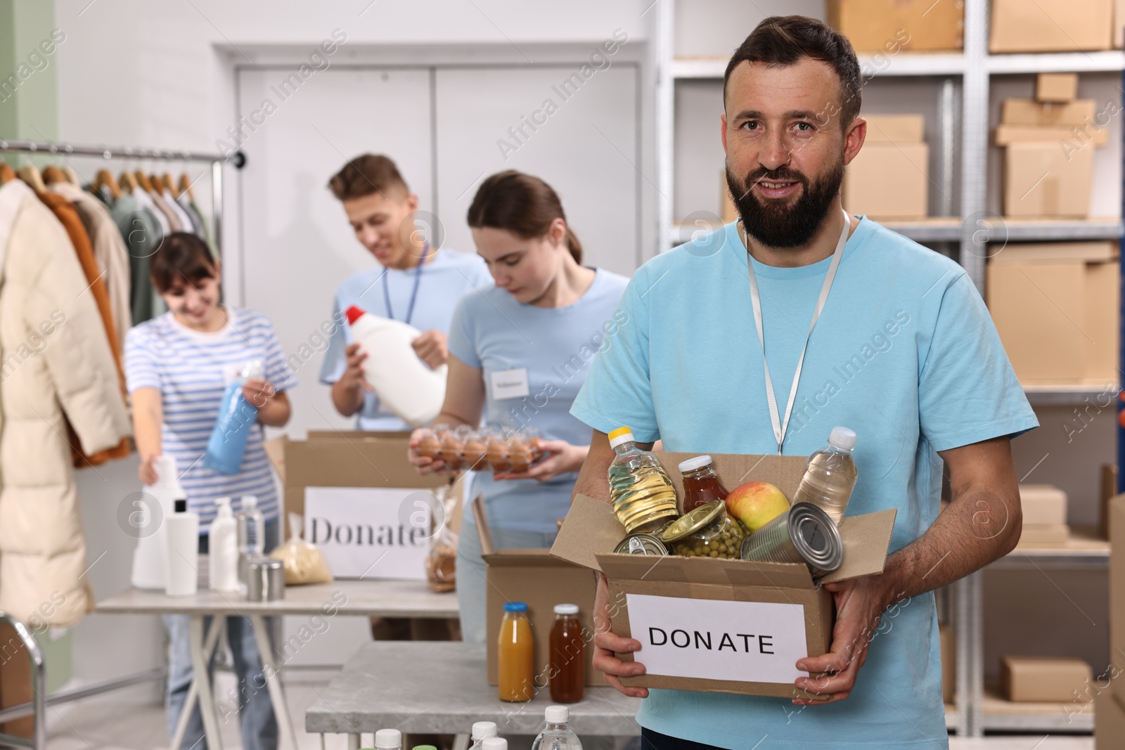 Photo of Group of volunteers packing donation goods indoors