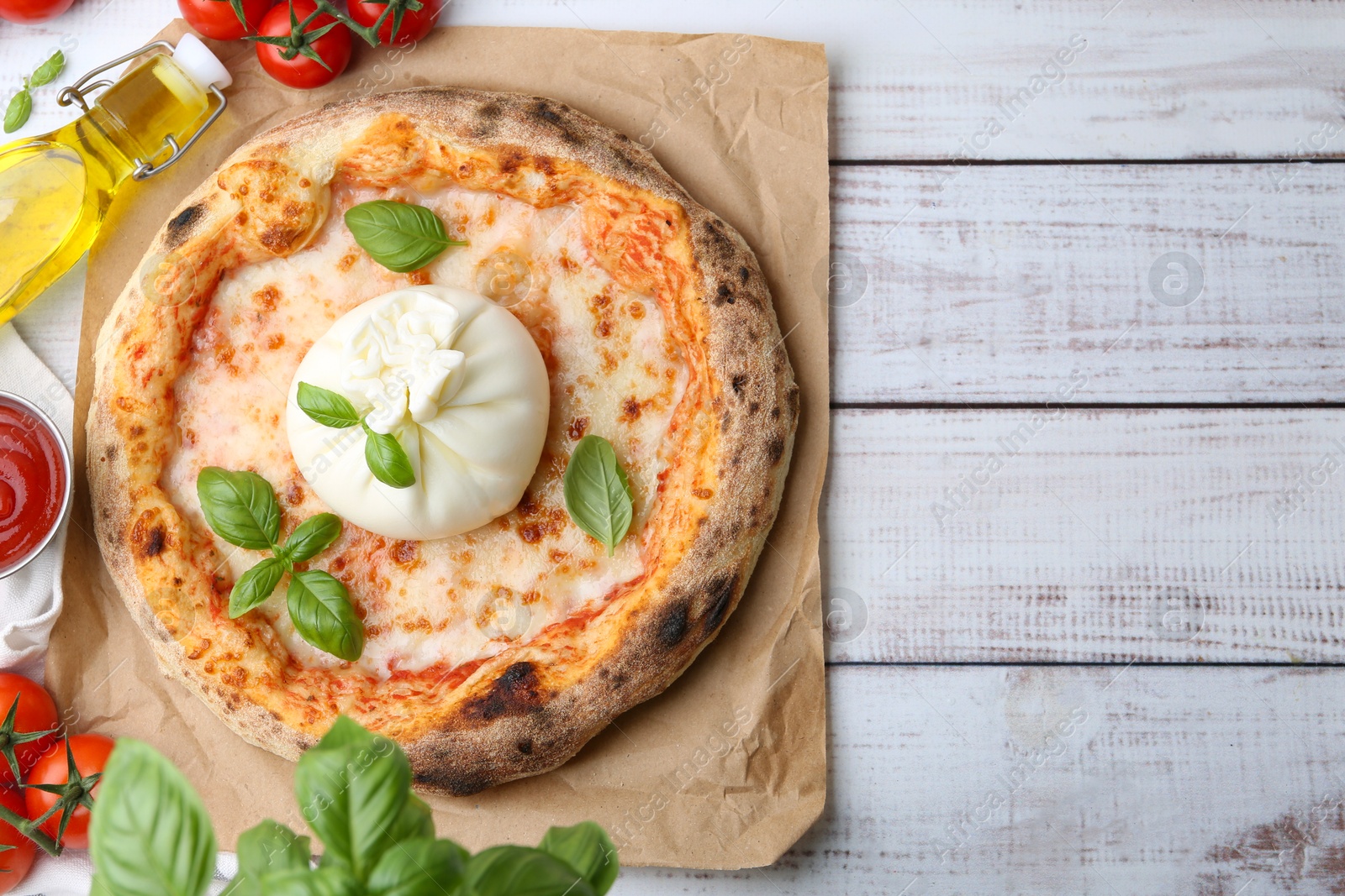 Photo of Delicious pizza with burrata cheese served on wooden table, top view. Space for text