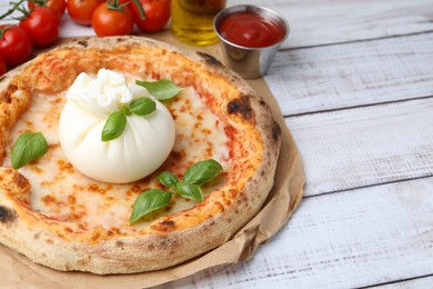 Photo of Delicious pizza with burrata cheese served on wooden table, closeup. Space for text