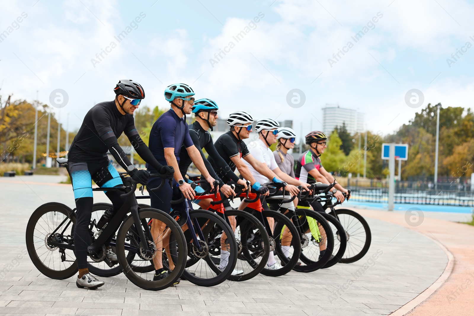 Photo of Group of athletic people with bicycles outdoors