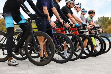 Photo of Group of athletic people with bicycles outdoors