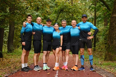 Photo of Group of athletic people together in park