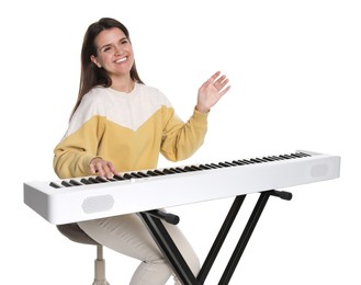 Photo of Smiling woman playing synthesizer on white background