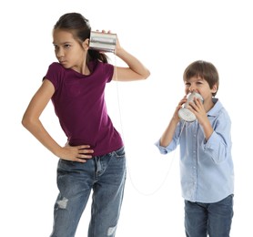 Photo of Girl and boy talking on tin can telephone against white background