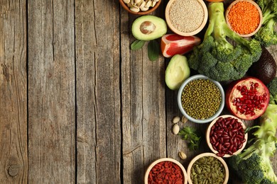 Photo of Different superfood products on wooden table, flat lay. Space for text