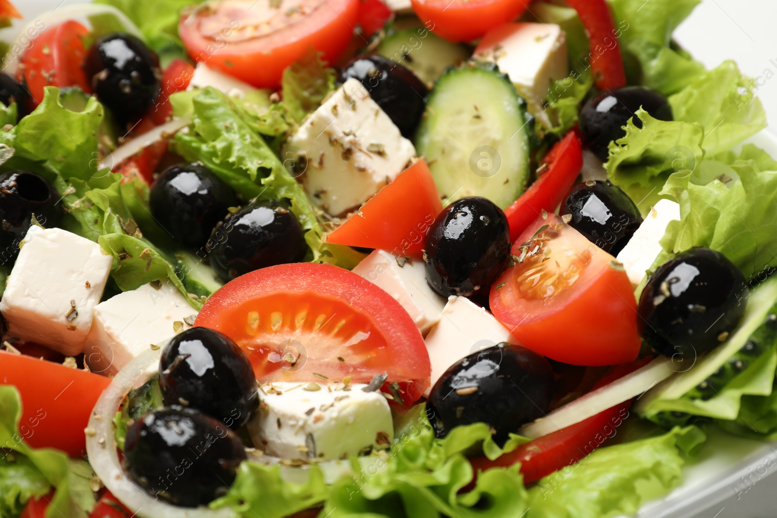 Photo of Delicious fresh Greek salad on plate, closeup