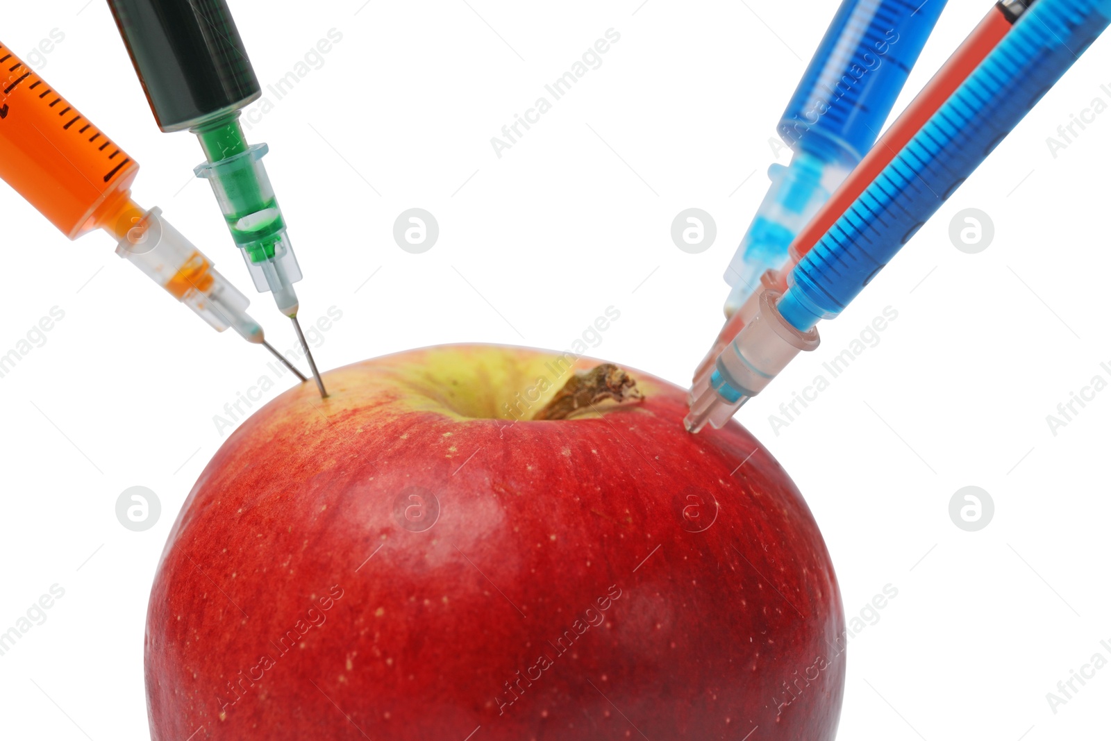 Photo of GMO concept. Fresh apple and syringes isolated on white