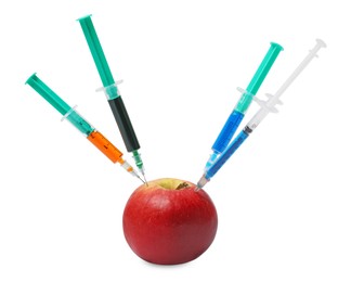 Photo of GMO concept. Fresh apple and syringes isolated on white