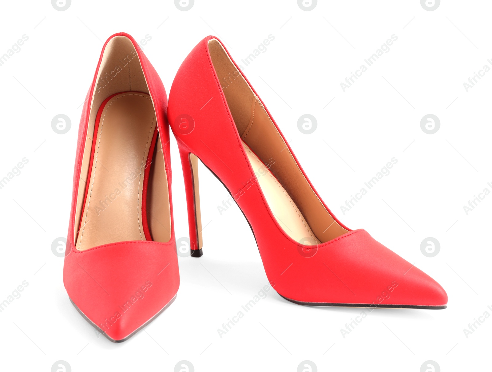 Photo of Pair of red high-heeled shoes isolated on white