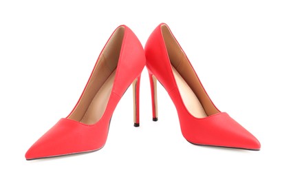 Photo of Pair of red high-heeled shoes isolated on white