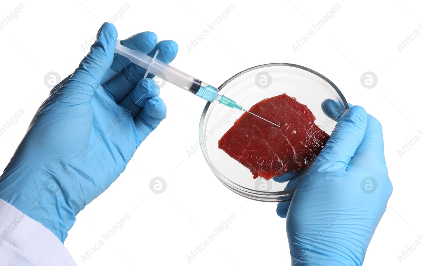 Photo of GMO concept. Scientist injecting something into piece of meat on white background, closeup