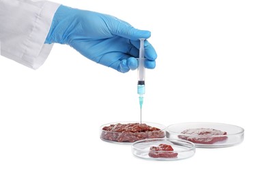 Photo of GMO concept. Scientist injecting something into minced meat on white background, closeup