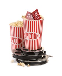 Photo of Tasty popcorn, film reels and movie tickets isolated on white