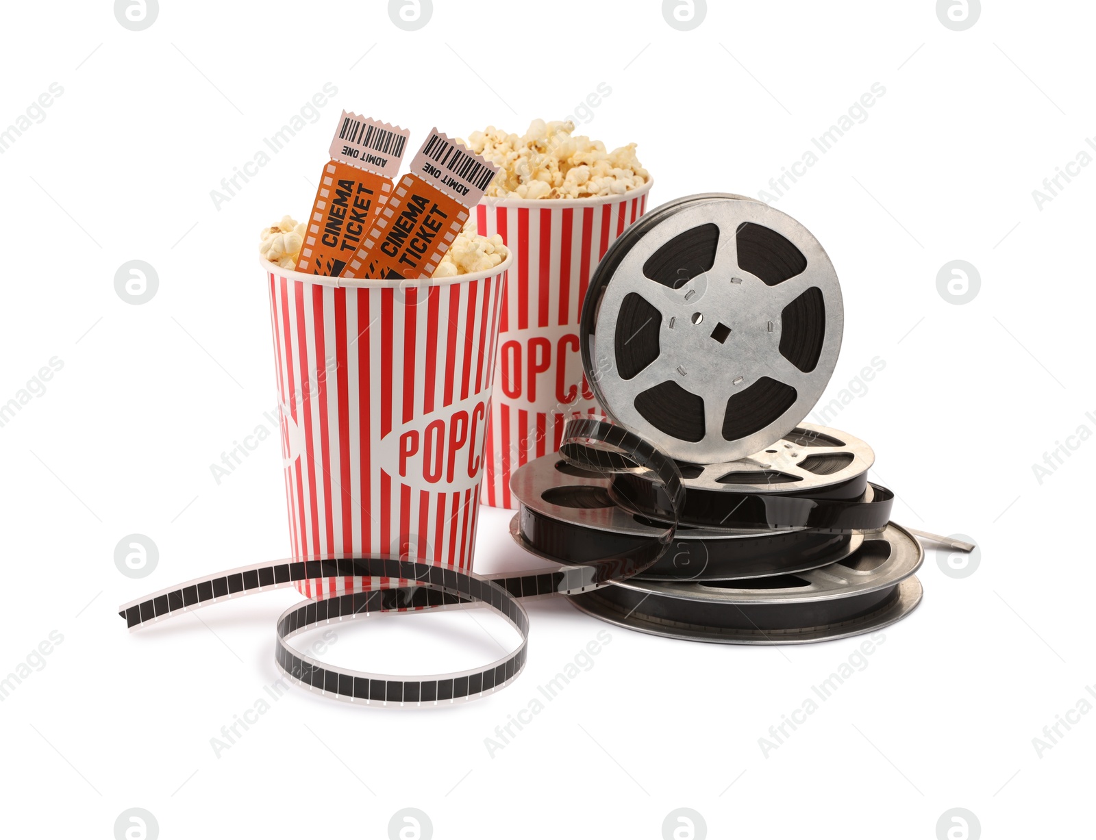 Photo of Tasty popcorn, film reels and movie tickets isolated on white