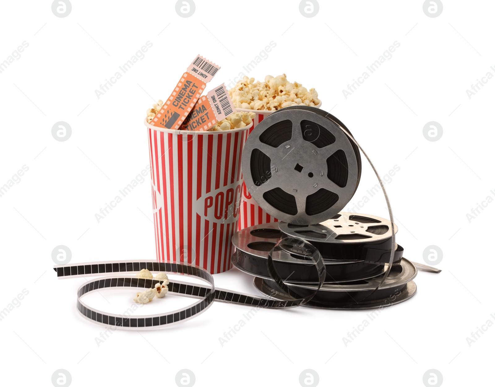 Photo of Tasty popcorn, film reels and movie tickets isolated on white