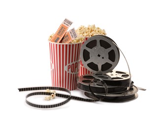 Photo of Tasty popcorn, film reels and movie tickets isolated on white