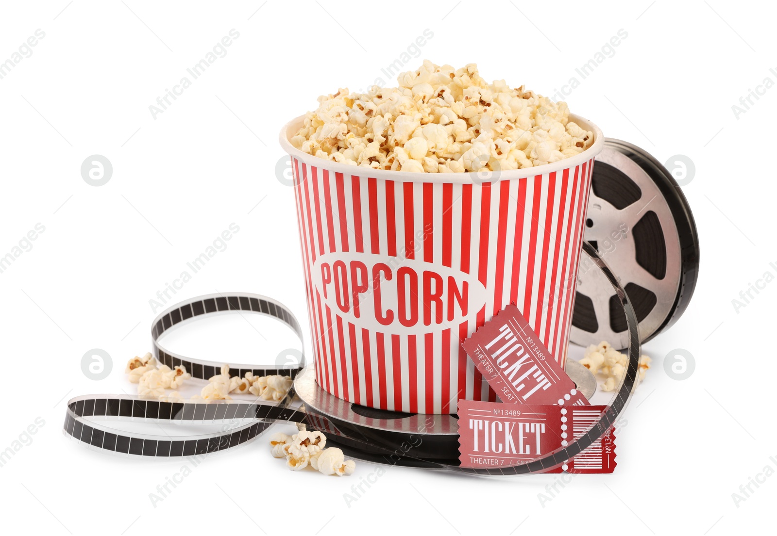 Photo of Tasty popcorn, film reel and movie tickets isolated on white