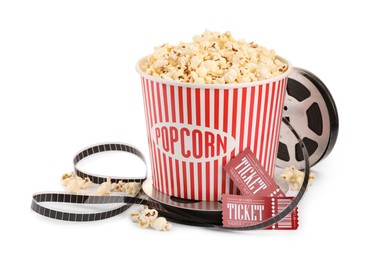 Photo of Tasty popcorn, film reel and movie tickets isolated on white