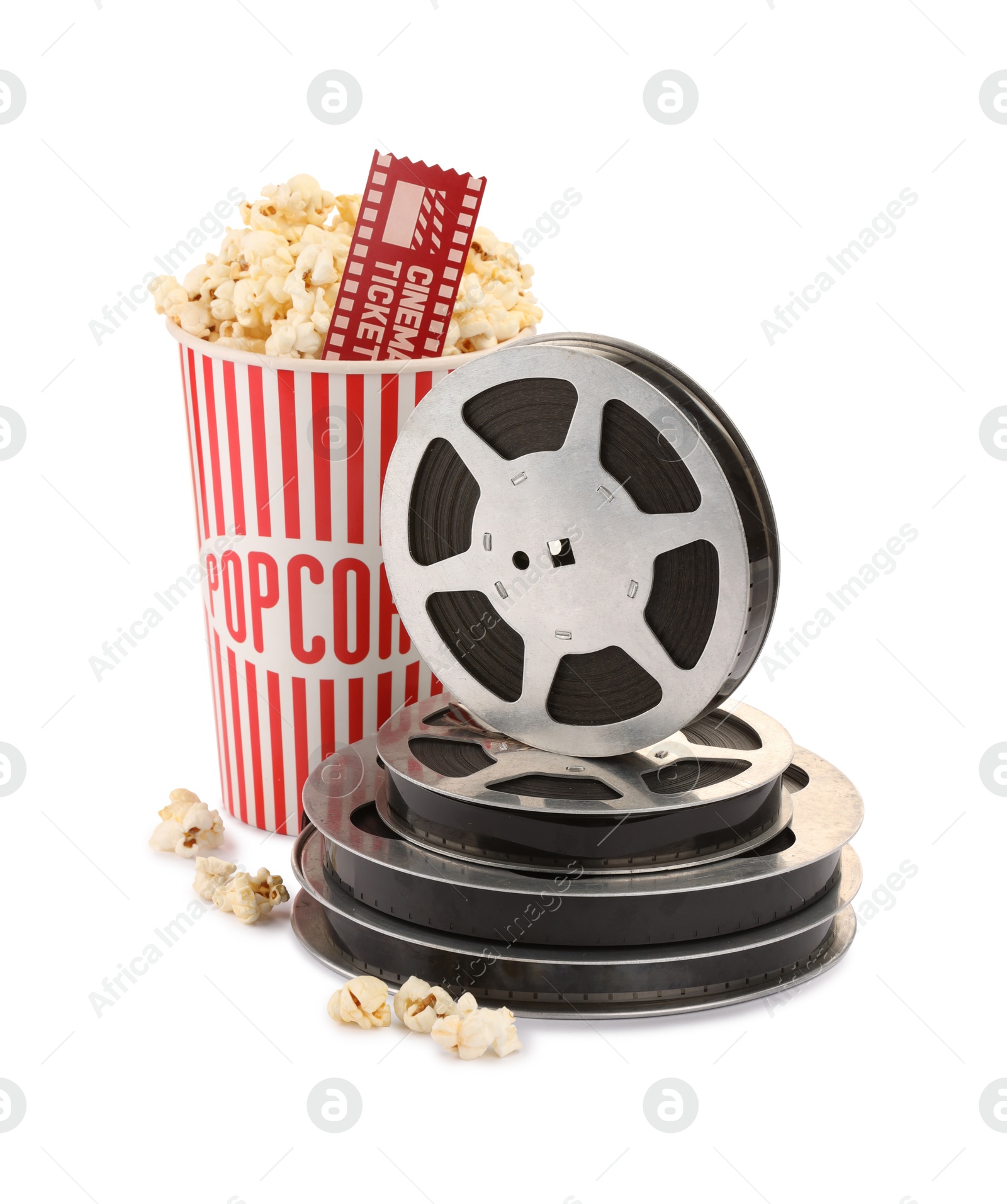 Photo of Tasty popcorn, film reels and movie ticket isolated on white