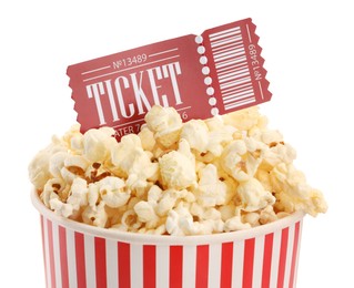 Photo of Tasty popcorn and movie ticket isolated on white