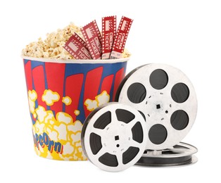 Photo of Tasty popcorn, film reels and movie tickets isolated on white