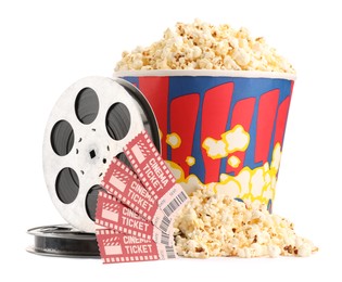 Photo of Tasty popcorn, film reels and movie tickets isolated on white