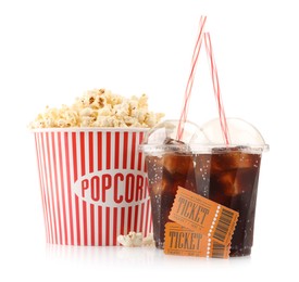 Photo of Tasty popcorn, drinks and movie tickets isolated on white