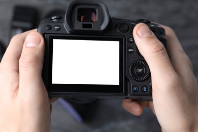 Photo of Photographer taking photo with professional camera in studio, top view