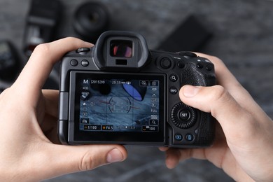 Photo of Photographer taking photo with professional camera in studio, top view