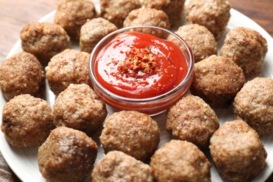 Photo of Delicious meatballs with ketchup and spices on table, closeup