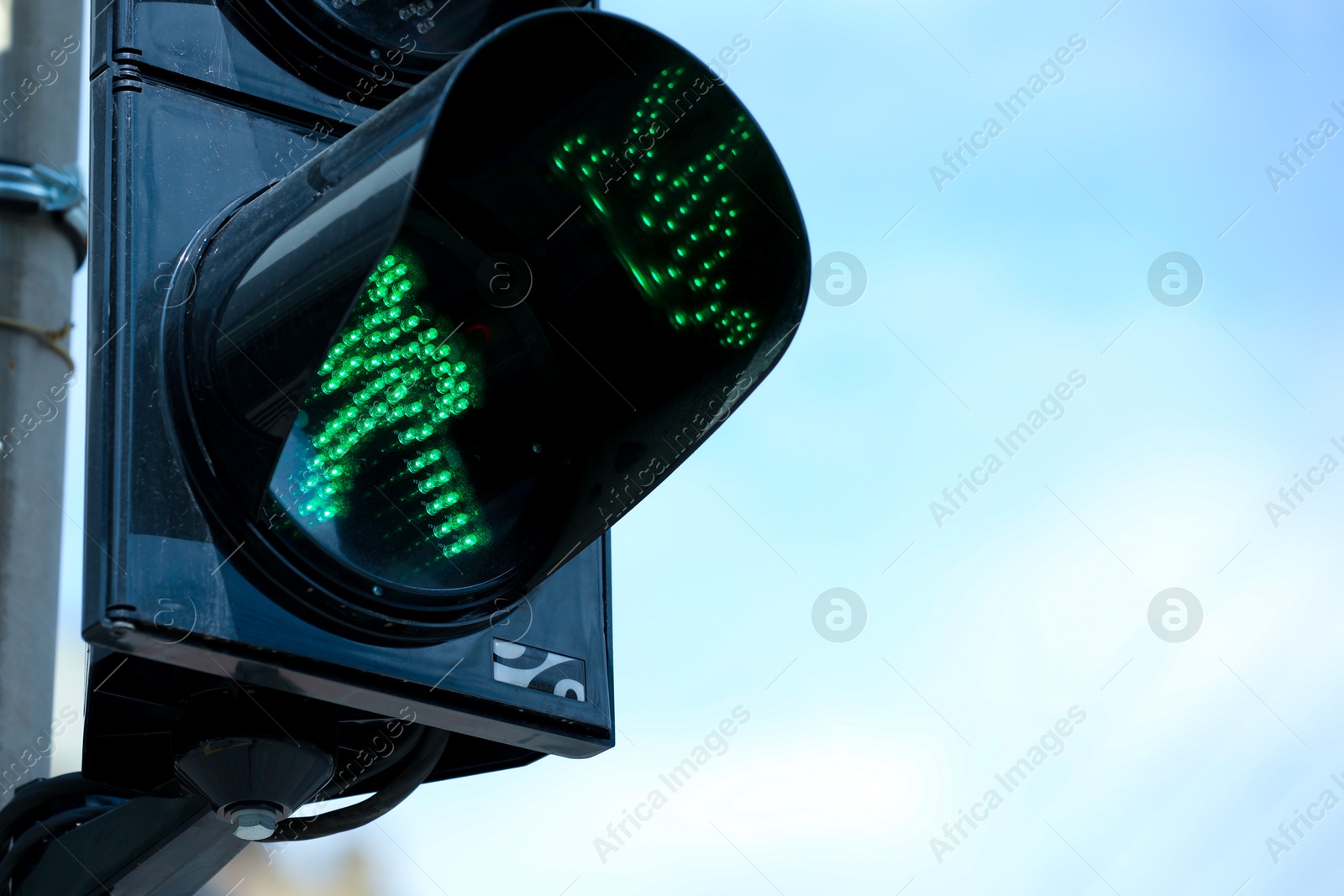 Photo of Closeup view of traffic light against blue sky. Space for text