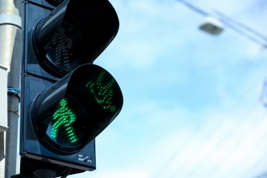 Photo of Closeup view of traffic light against blue sky. Space for text