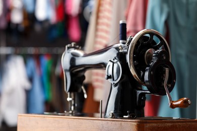 Photo of Vintage sewing machine with thread in workshop, closeup