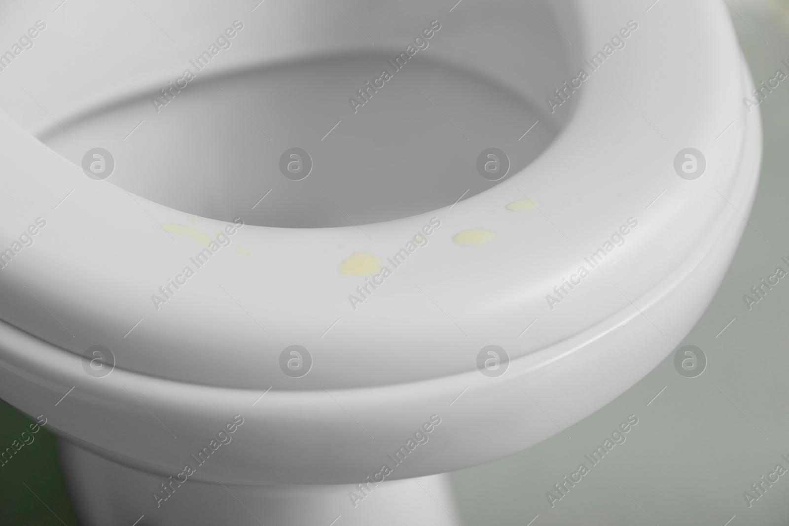 Photo of Urine drops on toilet seat in restroom, closeup