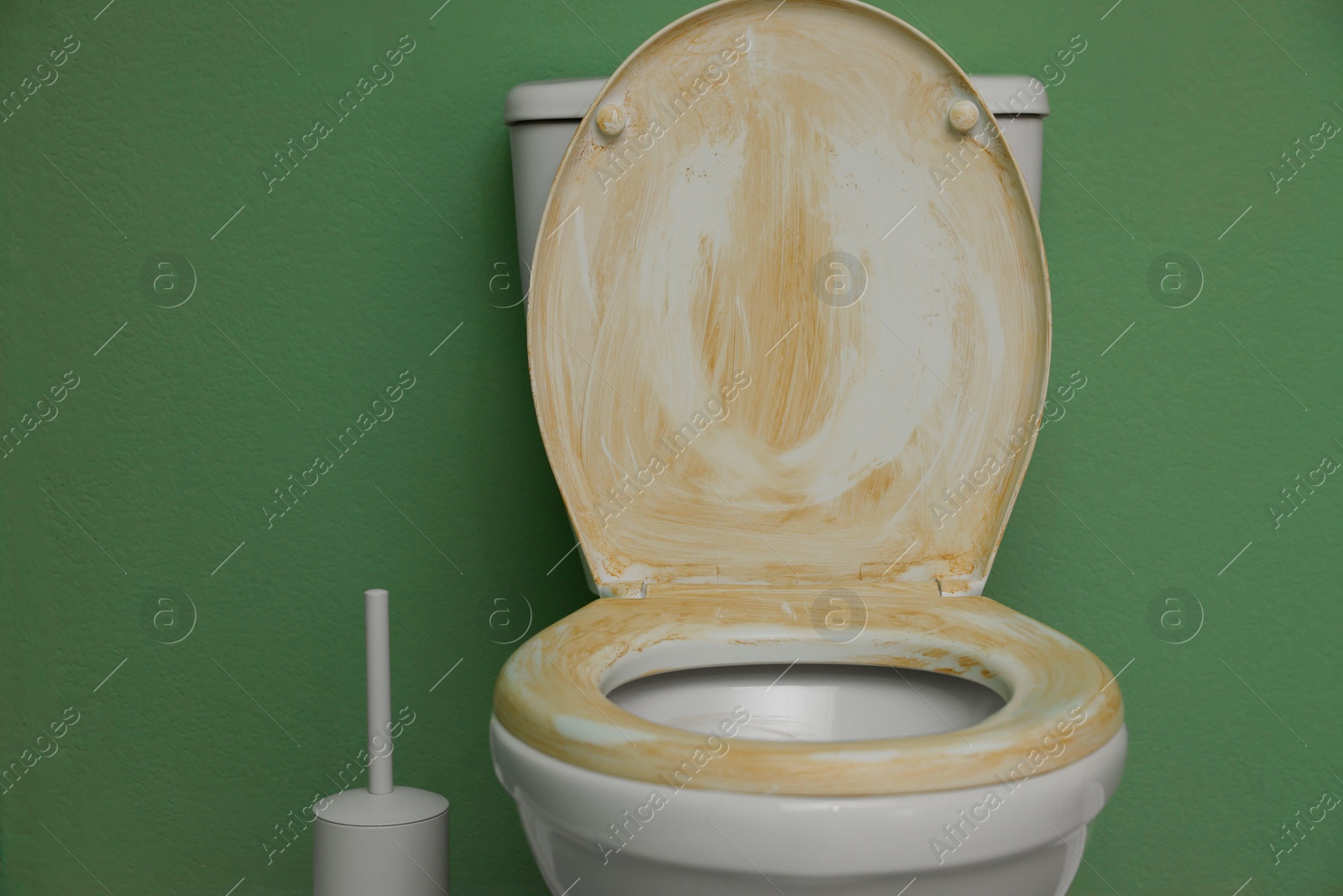 Photo of Toilet with dirty seat in public restroom