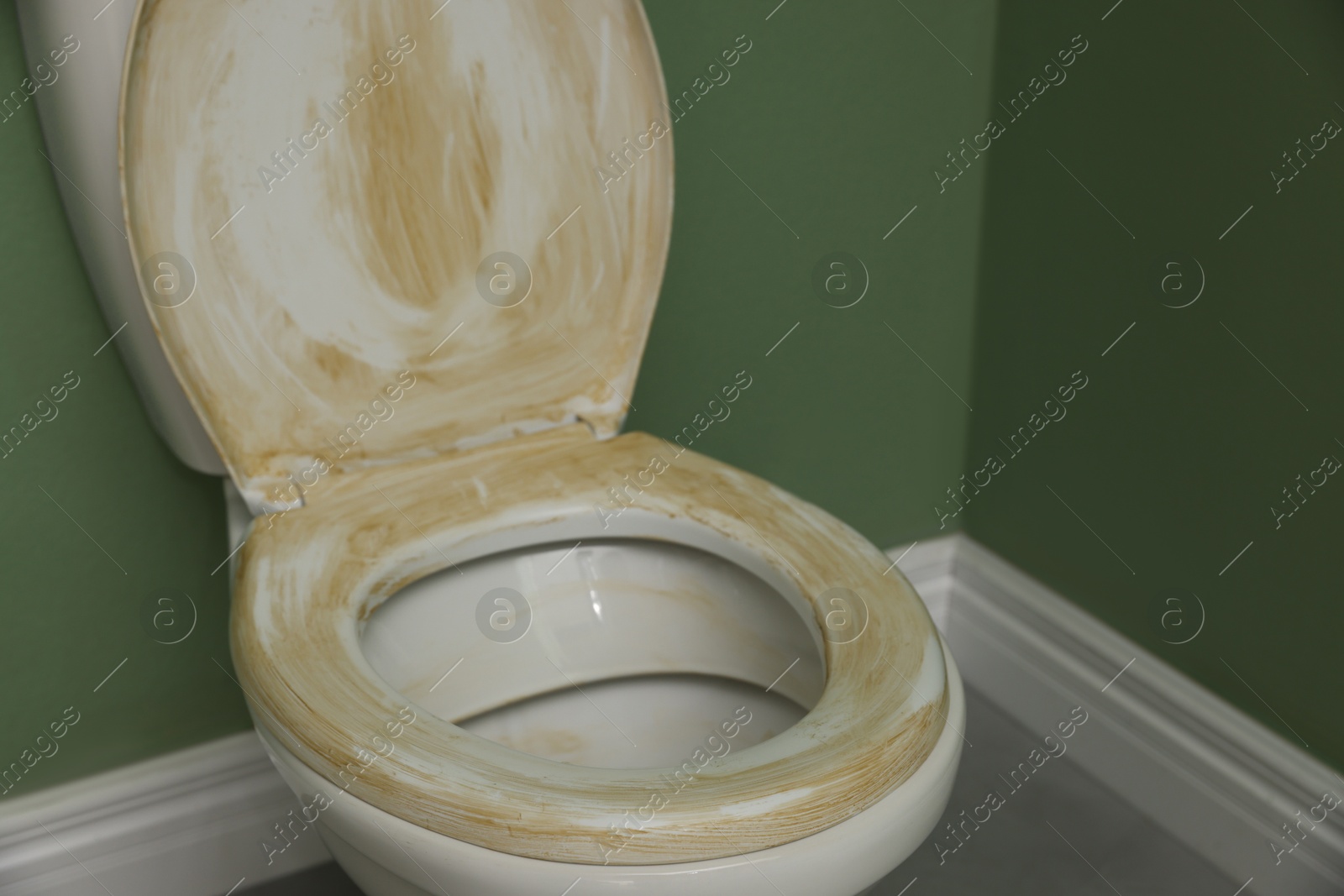 Photo of Toilet with dirty seat in public restroom