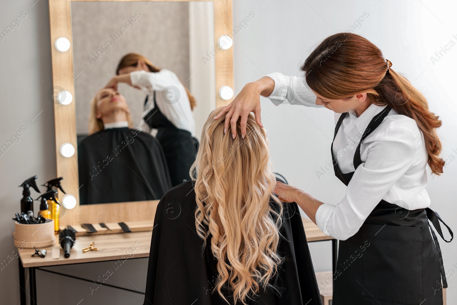 Photo of Hair cutting. Professional hairdresser working with client in salon