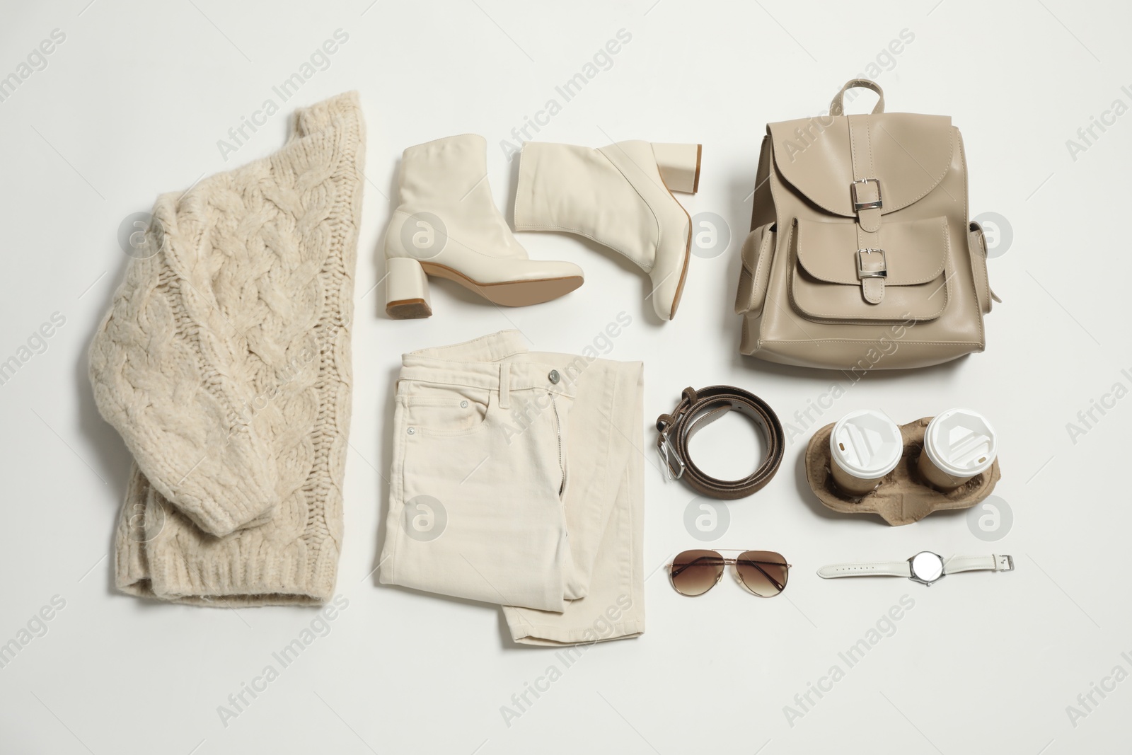 Photo of Stylish outfit with backpack on white background, flat lay