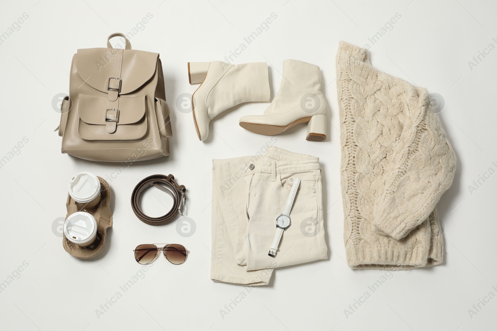 Photo of Stylish outfit with backpack on white background, flat lay