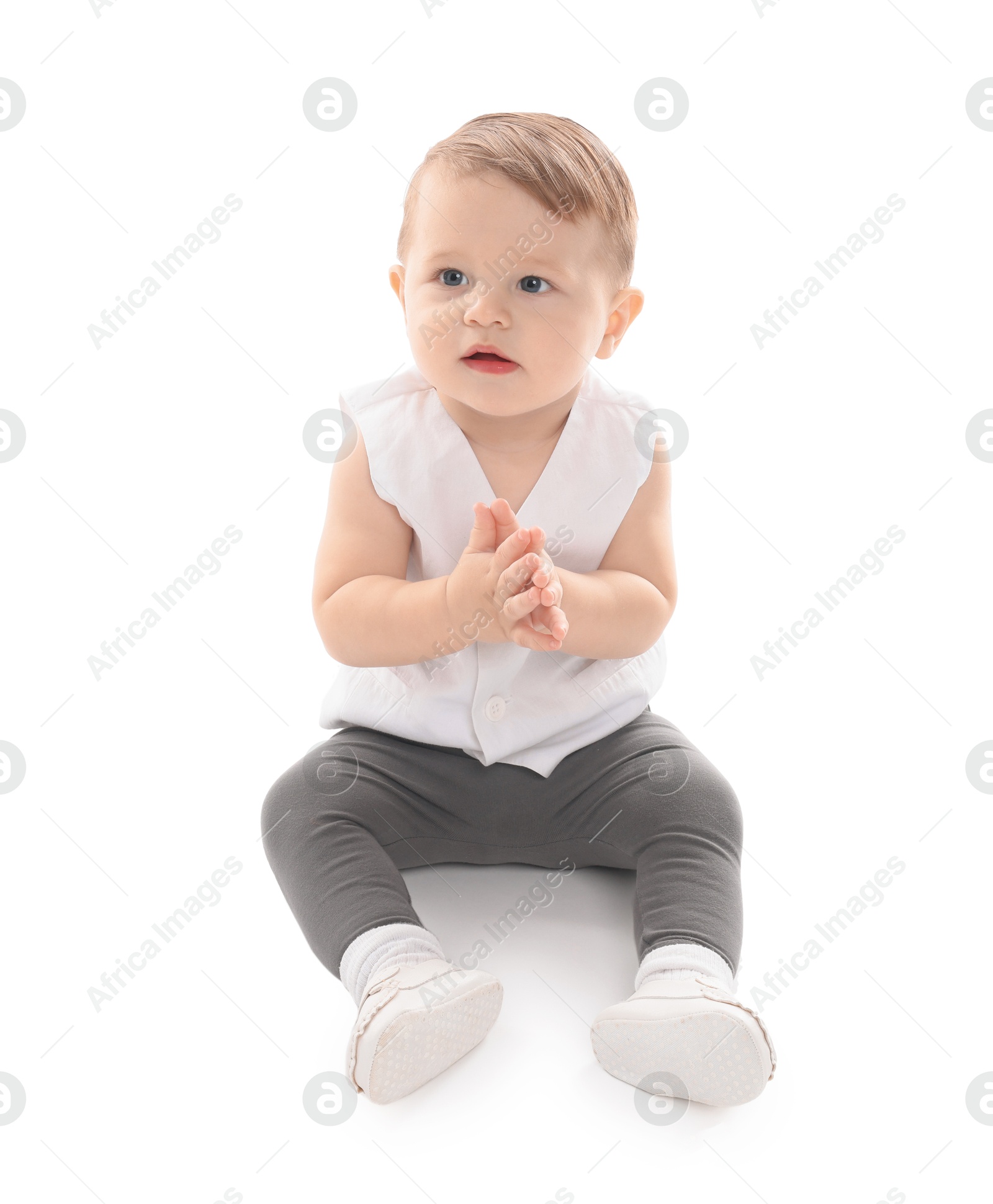 Photo of Cute little baby sitting on white background