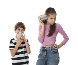 Photo of Girl and boy talking on tin can telephone against white background