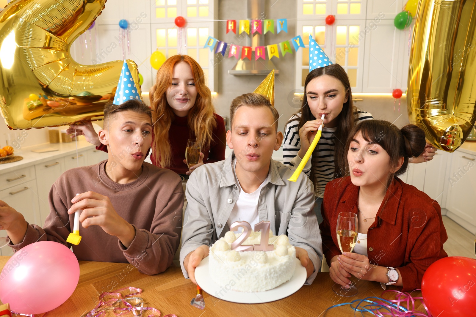 Photo of 21st birthday. Group of happy friends with tasty cake having coming of age party at home