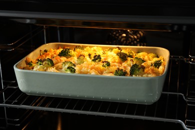 Photo of Baking dish with tasty pasta casserole in oven, closeup