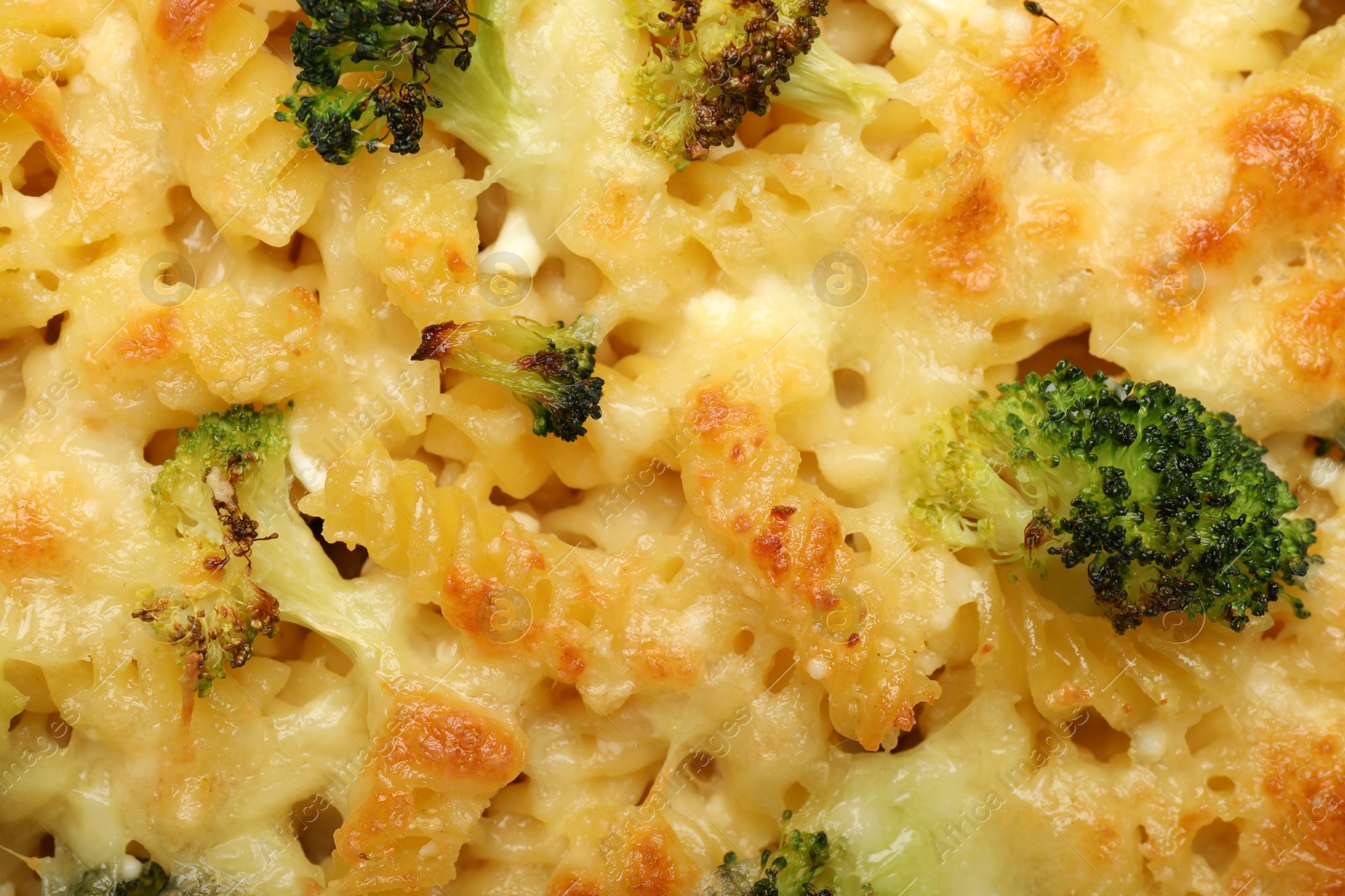 Photo of Tasty pasta casserole with cheese and broccoli as background, top view