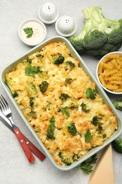 Photo of Tasty pasta casserole with cheese and broccoli served on grey table, flat lay