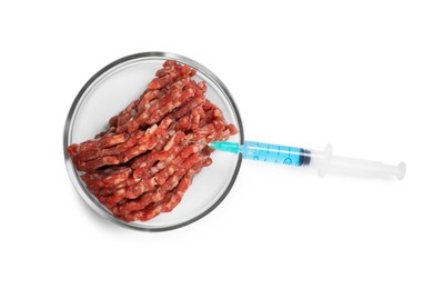 Photo of GMO concept. Minced meat and syringe isolated on white, top view